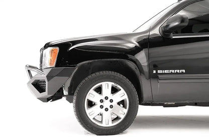 Fab Fours Vengeance front bumper with pre-runner guard on a black GMC Sierra 1500, side close-up of the front corner, showing the pre-runner tube, mesh-vented end wing and wheel clearance