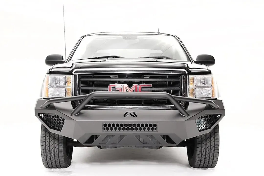Fab Fours Vengeance front bumper with pre-runner guard on a black GMC Sierra 1500, straight-on front view, showing the tubular pre-runner hoop, honeycomb mesh vents and center light bar cutout