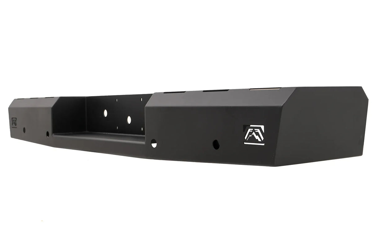 Fab Fours Red Steel rear bumper in black powder coat, opposite angled view, showing the faceted end cap, logo cutout and recessed center pocket