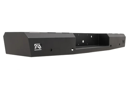 Fab Fours Red Steel rear bumper in black powder coat, angled view, showing the logo cutout end cap, recessed center hitch pocket and light mounting holes