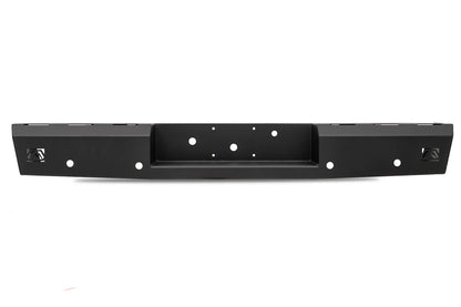 Fab Fours Red Steel rear bumper in black powder coat, straight-on rear view, showing the full-width face, recessed center hitch pocket and logo cutouts