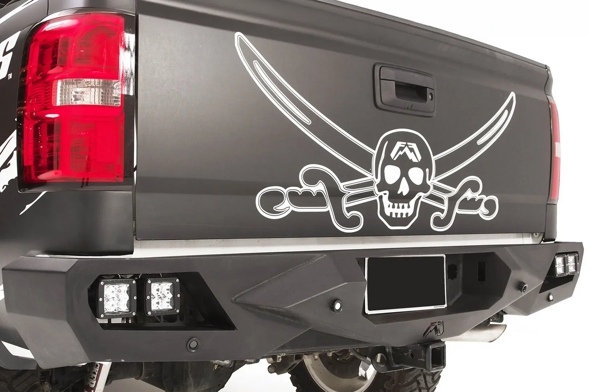Fab Fours Vengeance rear bumper on a black and white wrapped pickup, close-up of the rear corner, showing the cube light pods, angular end cap and license plate recess