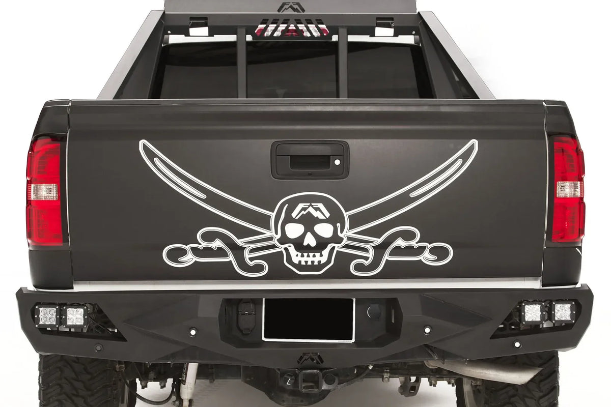 Fab Fours Vengeance rear bumper on a black and white wrapped pickup, straight-on rear view, showing the angular black steel face, cube light pods and center hitch area