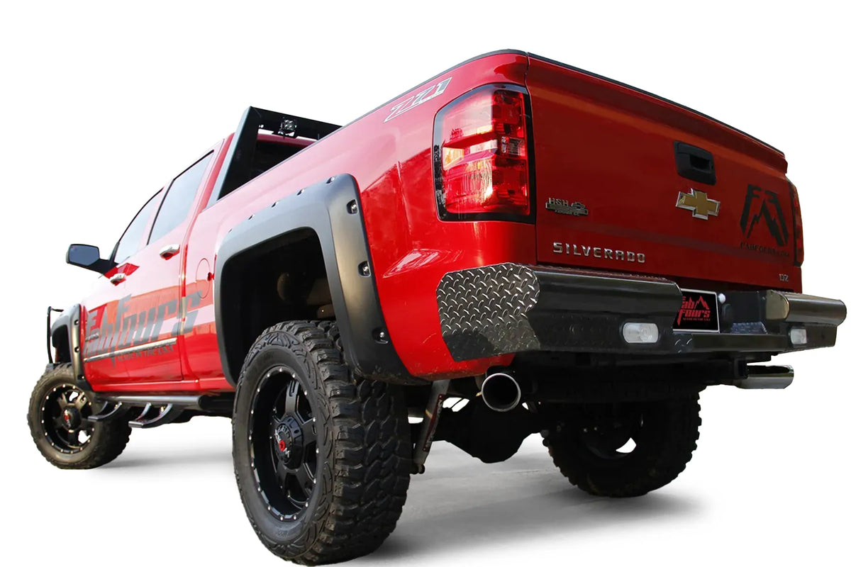 Fab Fours Black Steel Ranch Rear Bumper on a red Chevrolet Silverado 1500, rear driver-side view, showing the diamond tread plate end caps, pipe-style design and built-in back-up lights