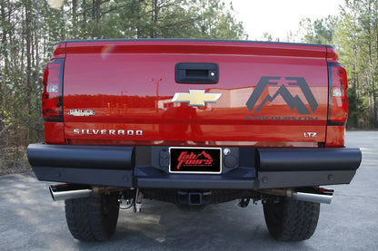 Fab Fours Black Steel Elite Rear Bumper on a red Chevrolet Silverado 1500 LTZ, rear view showing the full-width ranch-style bumper, center plate mount and OEM hitch