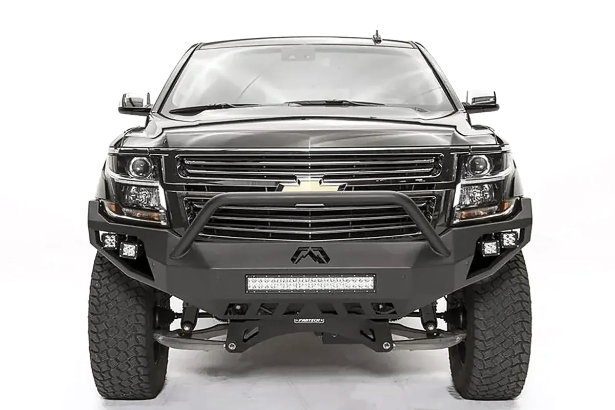 Fab Fours Vengeance front bumper with pre-runner guard on a black lifted Chevrolet Suburban, straight-on front view, showing the tubular pre-runner hoop, center light bar and cube light pods