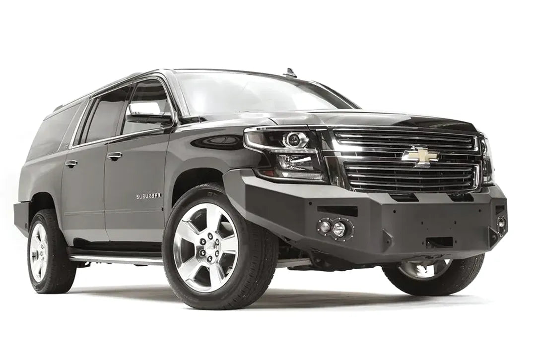 Fab Fours Premium Winch front bumper on a black Chevrolet Suburban, front passenger-side three-quarter view, showing the no-guard design, winch mount and angled end wing