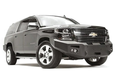 Fab Fours Premium Winch front bumper on a black Chevrolet Suburban, front passenger-side three-quarter view, showing the no-guard design, winch mount and angled end wing