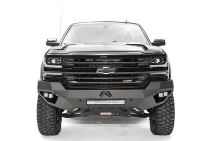 Fab Fours Vengeance front bumper on a black lifted Chevrolet Silverado 1500, straight-on front view, showing the full-width bumper face, center light bar and cube light pods