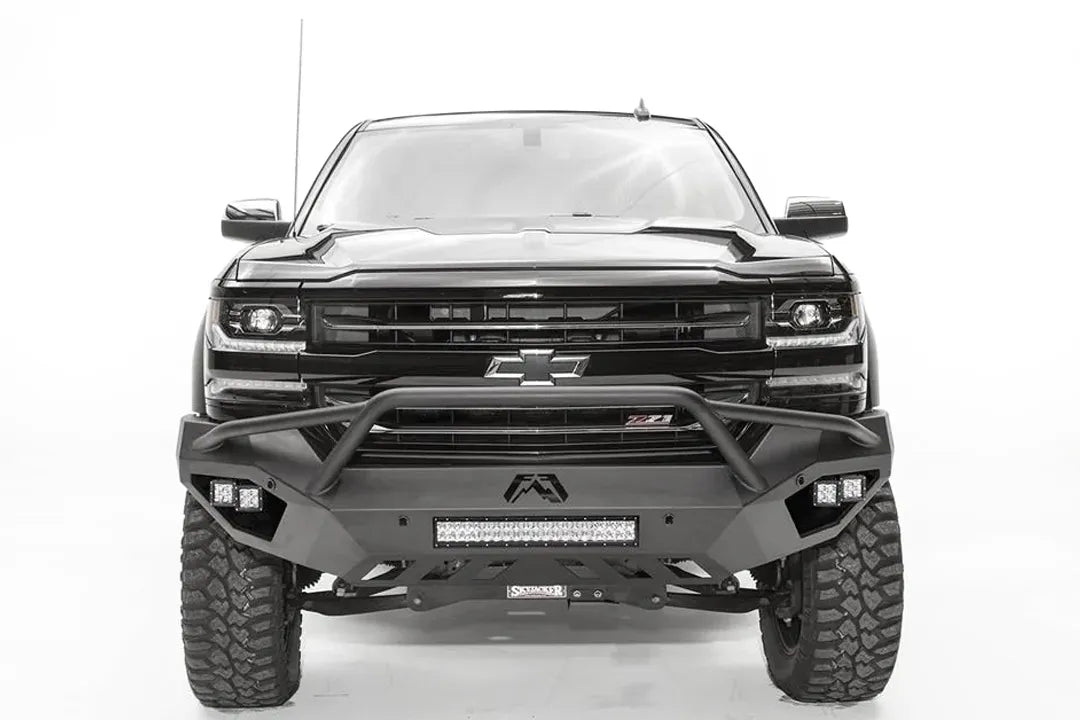 Fab Fours Vengeance front bumper with pre-runner guard on a black lifted Chevrolet Silverado 1500, straight-on front view, showing the tubular pre-runner hoop, center light bar and cube light pods