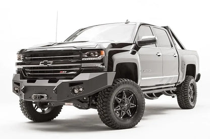 Fab Fours Premium front bumper on a black lifted Chevrolet Silverado 1500, front driver-side three-quarter view, showing the no-guard design, winch mount and angled end wing