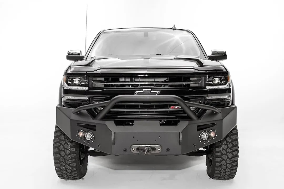 Fab Fours Premium front bumper with pre-runner guard on a black lifted Chevrolet Silverado 1500, straight-on front view, showing the pre-runner hoop, winch fairlead opening and round light cutouts