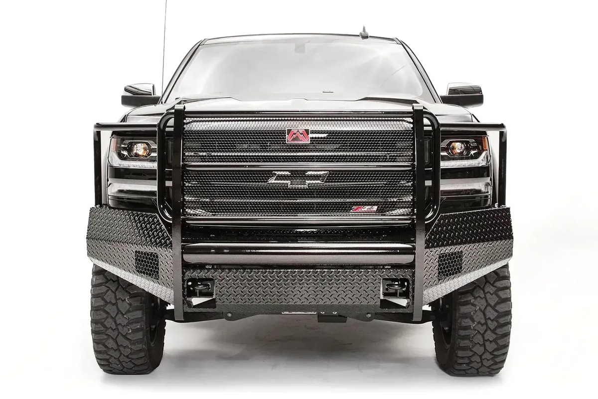 Fab Fours Black Steel front bumper with full guard on a black lifted Chevrolet Silverado 1500, straight-on front view, showing the full-width mesh grille guard, diamond-plate face and red logo plate