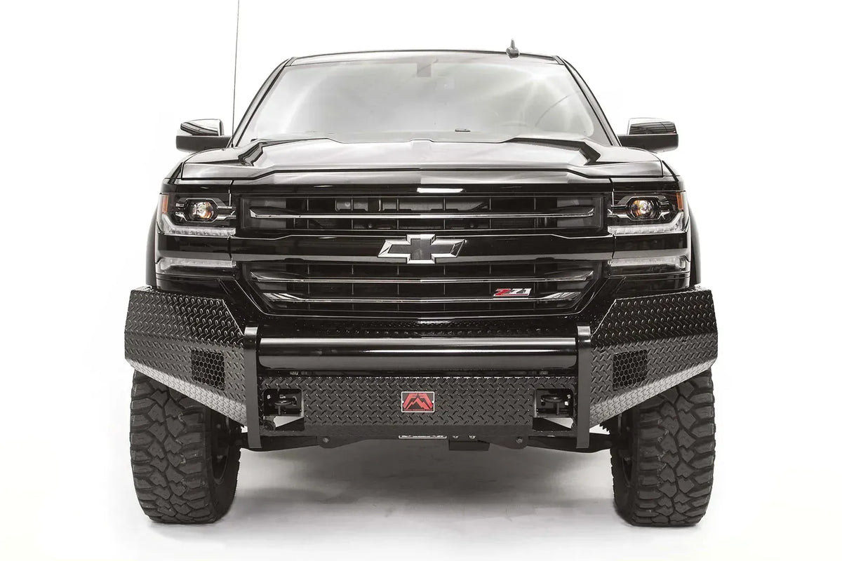 Fab Fours Black Steel front bumper on a black lifted Chevrolet Silverado 1500, straight-on front view, showing the no-guard design, diamond-plate face and red logo plate