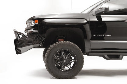 Fab Fours Black Steel front bumper with pre-runner guard on a black Chevrolet Silverado 1500, driver-side profile view, showing the bumper wing depth, pre-runner tubing, and tire clearance
