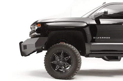 Fab Fours Elite front bumper with pre-runner guard on a lifted black Chevrolet Silverado 1500, driver-side profile, showing the angular steel bumper end ahead of the front wheel
