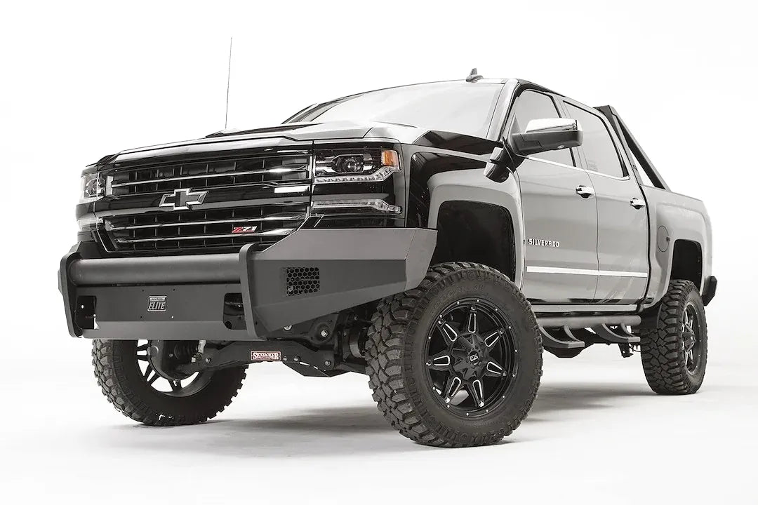 Fab Fours Elite front bumper with pre-runner guard on a lifted Chevrolet Silverado 1500 Z71, low front driver-side view, showing the tubular guard across the grille and Elite badge
