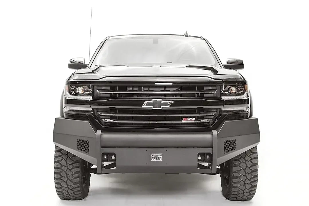 Fab Fours Elite front bumper with pre-runner guard on a black 2016–2018 Chevrolet Silverado 1500, front view showing the low tubular guard, honeycomb side vents, shackle mounts and Elite badge