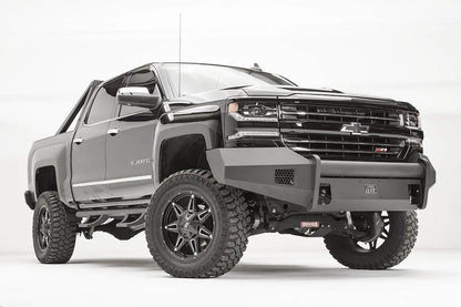Fab Fours Elite front bumper with pre-runner guard on a lifted Chevrolet Silverado 1500 Z71, low front passenger-side view, with honeycomb vents and matte black steel construction