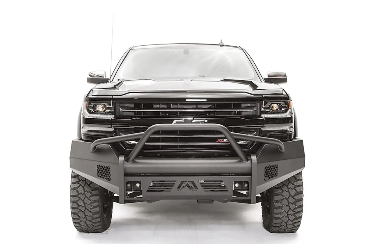 Fab Fours Elite front bumper with pre-runner guard on a black 2016–2018 Chevrolet Silverado 1500, front view showing the tubular hoop over the grille, honeycomb side vents and Fab Fours logo skid plate
