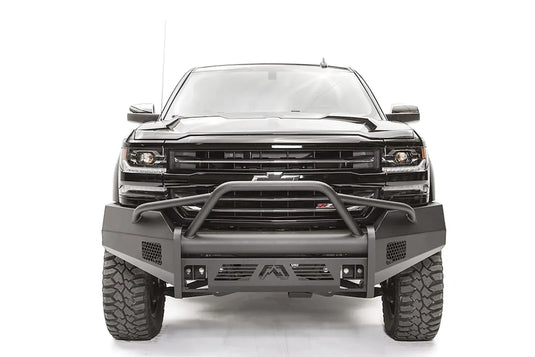 Fab Fours Elite front bumper with pre-runner guard on a black 2016–2018 Chevrolet Silverado 1500, front view showing the tubular hoop over the grille, honeycomb side vents and Fab Fours logo skid plate