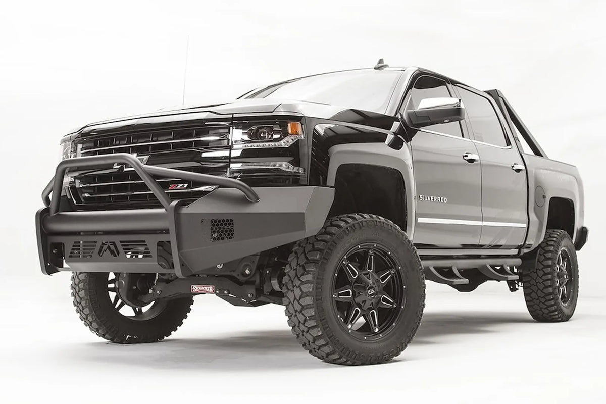 Fab Fours Elite front bumper with pre-runner guard on a lifted Chevrolet Silverado 1500 Z71, low front driver-side view, showing the tubular hoop and matte black steel bumper