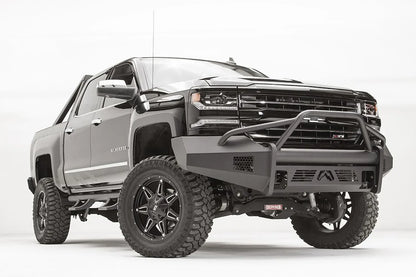 Fab Fours Elite front bumper with pre-runner guard on a lifted Chevrolet Silverado 1500 Z71, low front passenger-side view, with the tubular hoop, honeycomb vents and logo skid plate