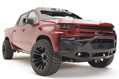 Fab Fours Vengeance front bumper with pre-runner guard on a red Chevrolet Silverado 1500, front passenger-side three-quarter view, showing the pre-runner tubing, plated center section, and integrated lights