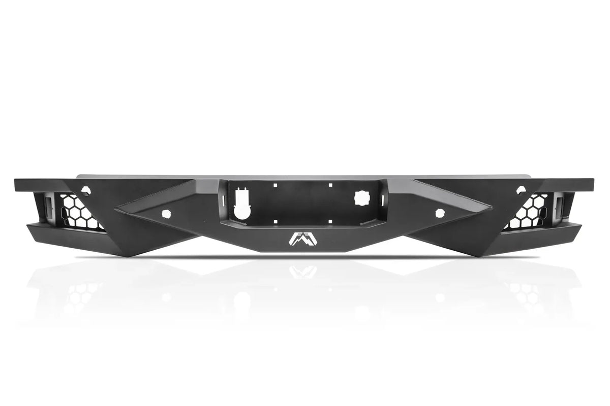 Fab Fours Vengeance rear bumper in black powder coat, straight-on rear view, showing the honeycomb light pockets, center plate recess, and Fab Fours logo
