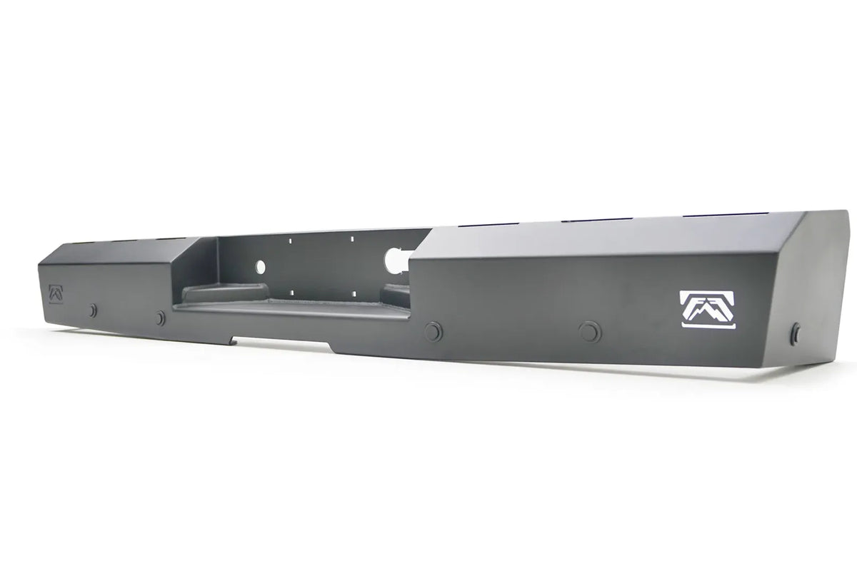 Fab Fours Red Steel rear bumper in black powder coat, angled view, showing the center hitch recess, end-cap Fab Fours logos, and mounting bolts