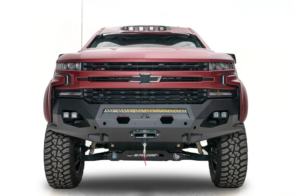 Fab Fours Matrix Front Winch Bumper with no guard on a red Chevrolet Silverado 1500, front view, showing the center LED light bar, cube lights on each side, winch fairlead and synthetic winch line