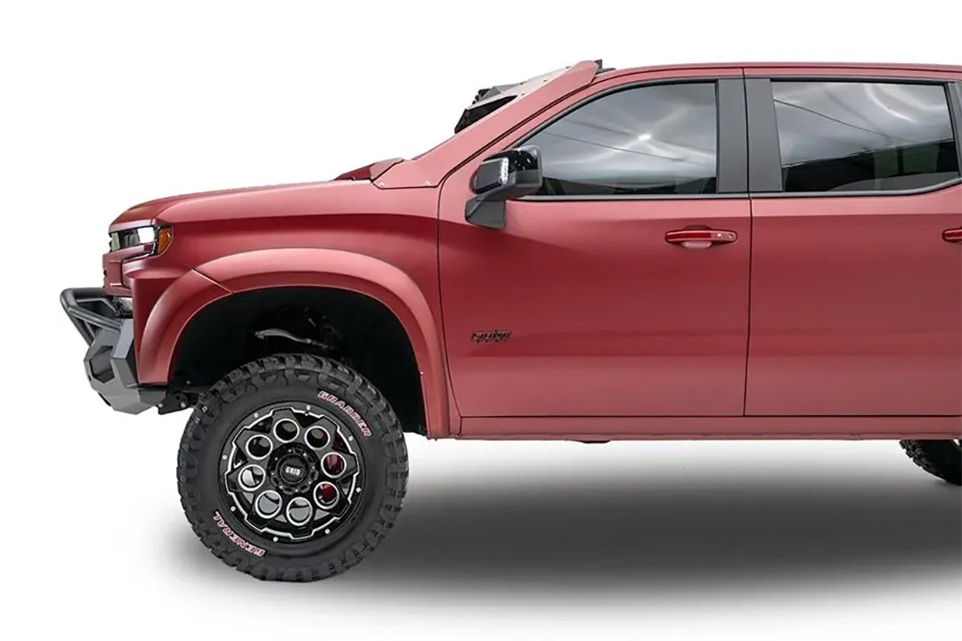Fab Fours Matrix Front Winch Bumper with pre-runner guard on a red Chevrolet Silverado 1500, driver-side profile, showing how the bumper and guard sit tight to the front fender