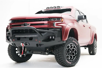 Fab Fours Matrix Front Winch Bumper with pre-runner guard on a lifted red Chevrolet Silverado 1500, front driver-side view, with LED light bar, side cube lights