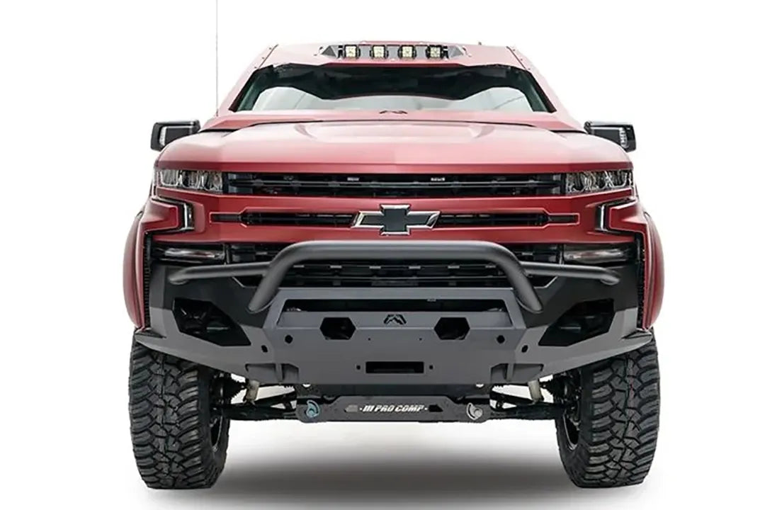 Fab Fours Matrix Front Winch Bumper with pre-runner guard on a red Chevrolet Silverado 1500, front view, showing the tubular guard, Fab Fours logo plate and open light mounts