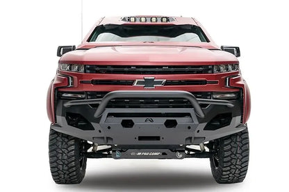 Fab Fours Matrix Front Winch Bumper with pre-runner guard on a red Chevrolet Silverado 1500, front view, showing the tubular guard, Fab Fours logo plate and open light mounts