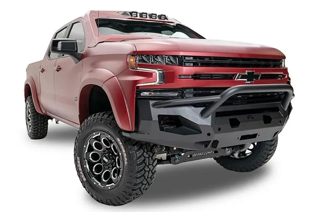 Fab Fours Matrix Front Winch Bumper with pre-runner guard on a red Chevrolet Silverado 1500, front passenger-side view, showing the angular steel bumper, tubular guard and light mount openings