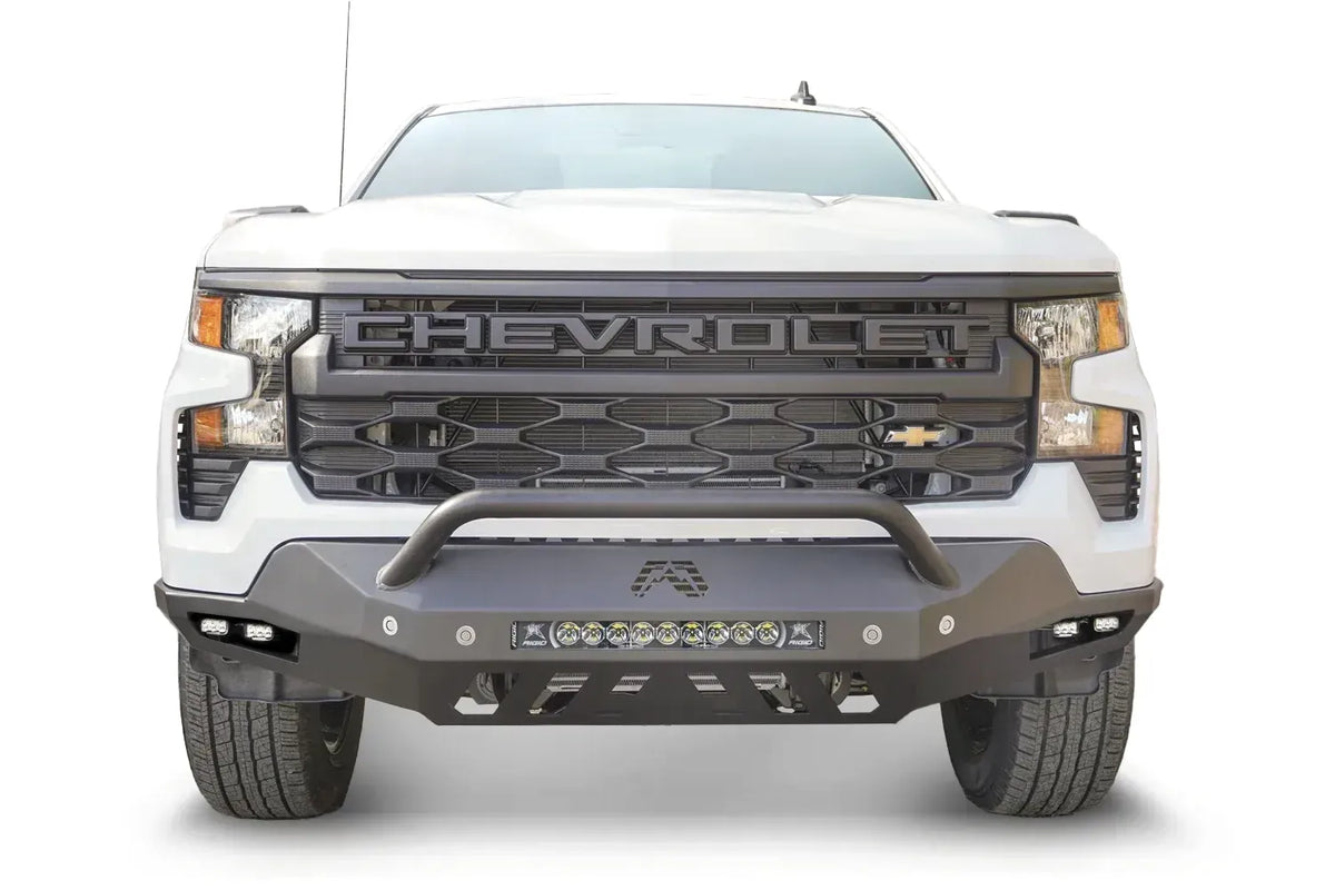 Fab Fours Vengeance front bumper with pre-runner guard on a white Chevrolet Silverado 1500, straight-on front view, showing the pre-runner bar, LED light bar, and cube light pods