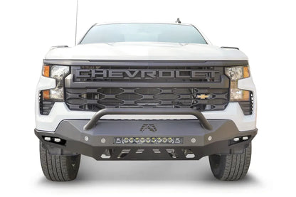 Fab Fours Vengeance front bumper with pre-runner guard on a white Chevrolet Silverado 1500, straight-on front view, showing the pre-runner bar, LED light bar, and cube light pods