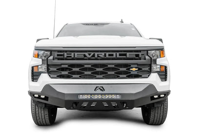 Fab Fours Vengeance front bumper on a white Chevrolet Silverado 1500, straight-on front view, showing the center LED light bar, Fab Fours logo, and corner cube lights