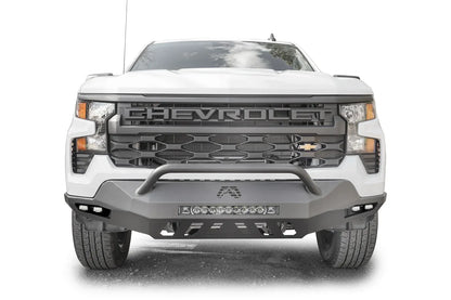 Fab Fours Vengeance front bumper with pre-runner guard on a white Chevrolet Silverado 1500, straight-on front view, showing the pre-runner bar, center LED light bar, and slotted skid plate