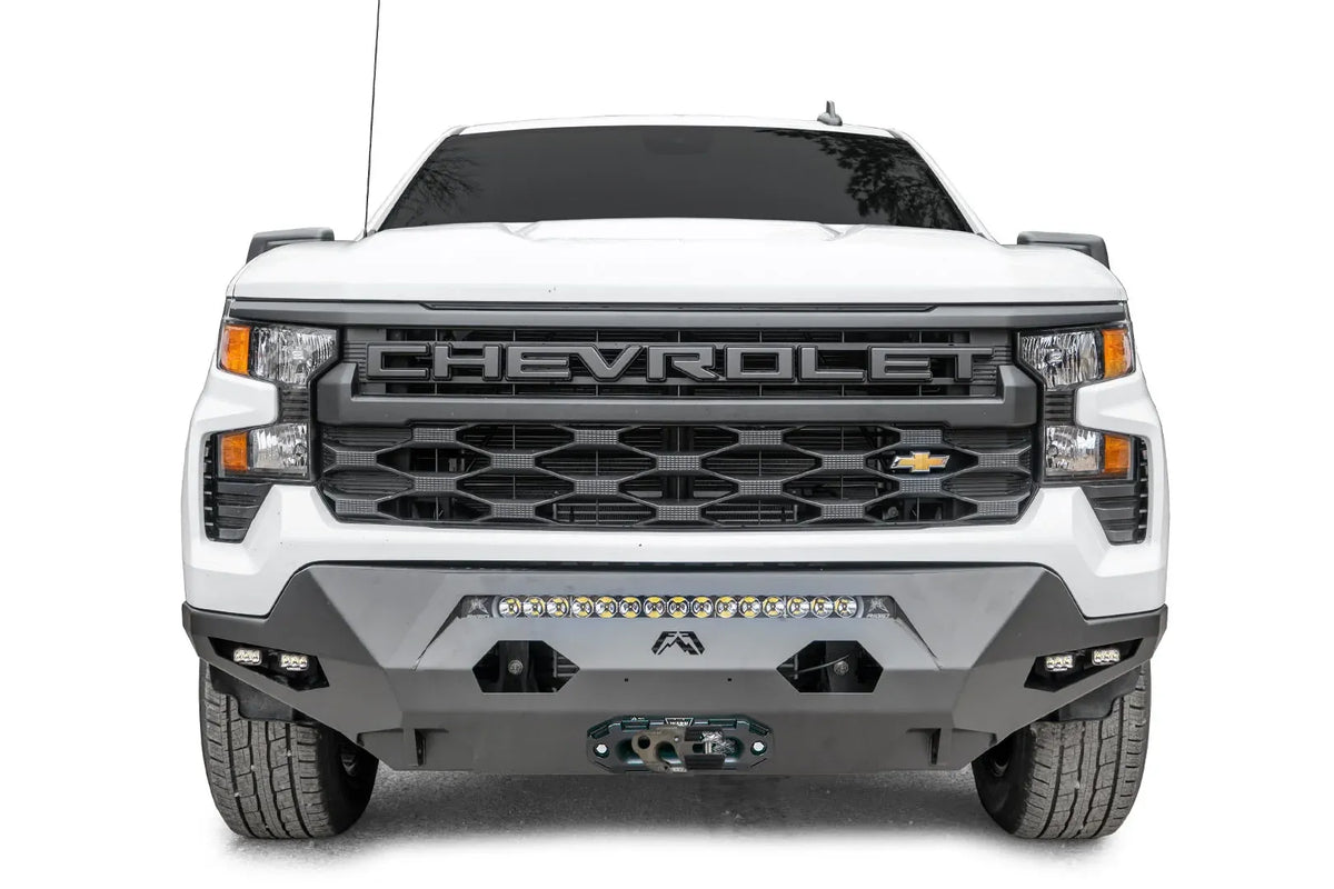 Fab Fours Matrix Front Bumper on a white 2022+ Chevrolet Silverado 1500, front view, showing the center LED light bar, two cube lights per side and the winch fairlead mount