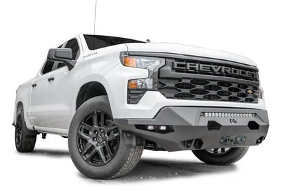 Fab Fours Matrix Front Bumper on a white Chevrolet Silverado 1500, front passenger-side view, showing the slim no-guard design with light bar, side cube lights and Fab Fours logo