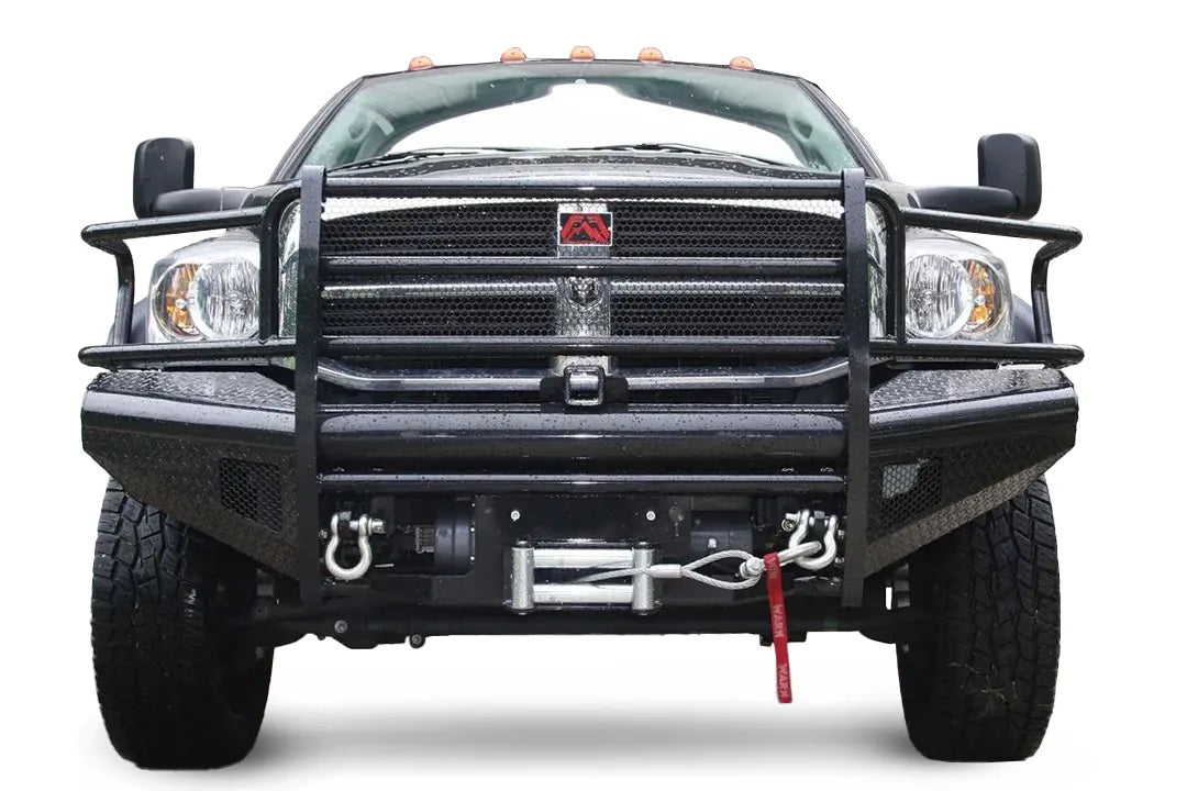 Fab Fours Black Steel front bumper with full guard on a black Ram 2500, straight-on front view, showing the full grille guard, diamond-plate face, winch with D-ring shackles