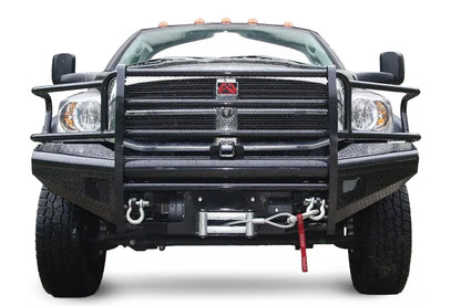 Fab Fours Black Steel front bumper with full guard on a black Ram 2500, straight-on front view, showing the full grille guard, diamond-plate face, winch with D-ring shackles