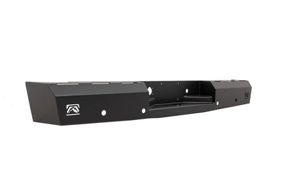 Fab Fours Red Steel rear bumper in black powder coat, angled view, showing the center hitch recess, logo end caps, and light cutouts
