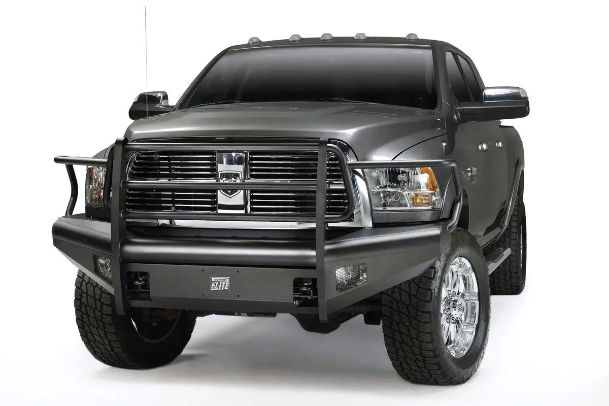 Fab Fours Black Steel Elite front bumper with full guard on a gray Ram 2500, front driver-side three-quarter view, showing the full grille guard uprights, headlight hoops, and integrated fog light openings