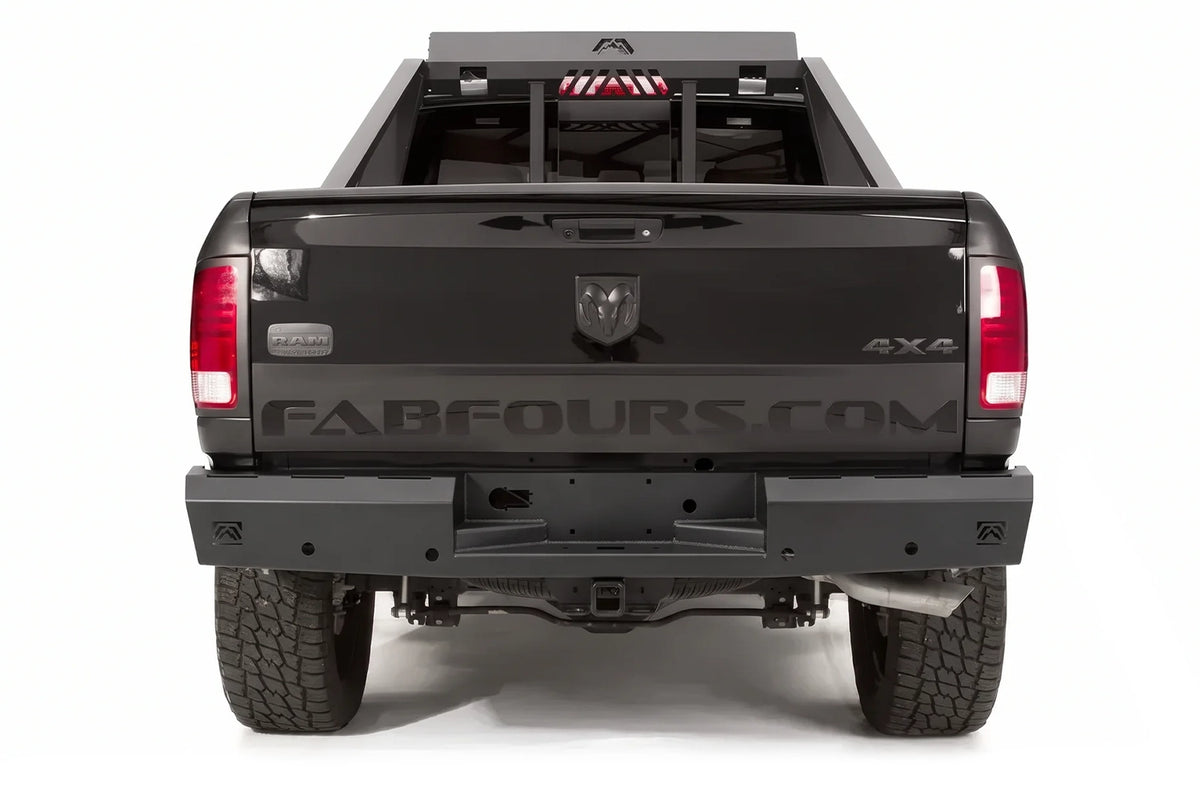 Fab Fours Red Steel rear bumper and bed chase rack on a black Ram 1500
