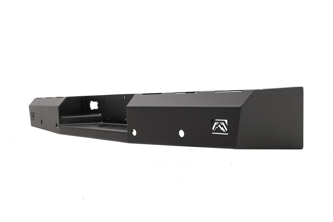 Fab Fours Red Steel rear bumper in black powder coat, opposite angled view, showing the hitch recess, logo end cap, and slotted top edge