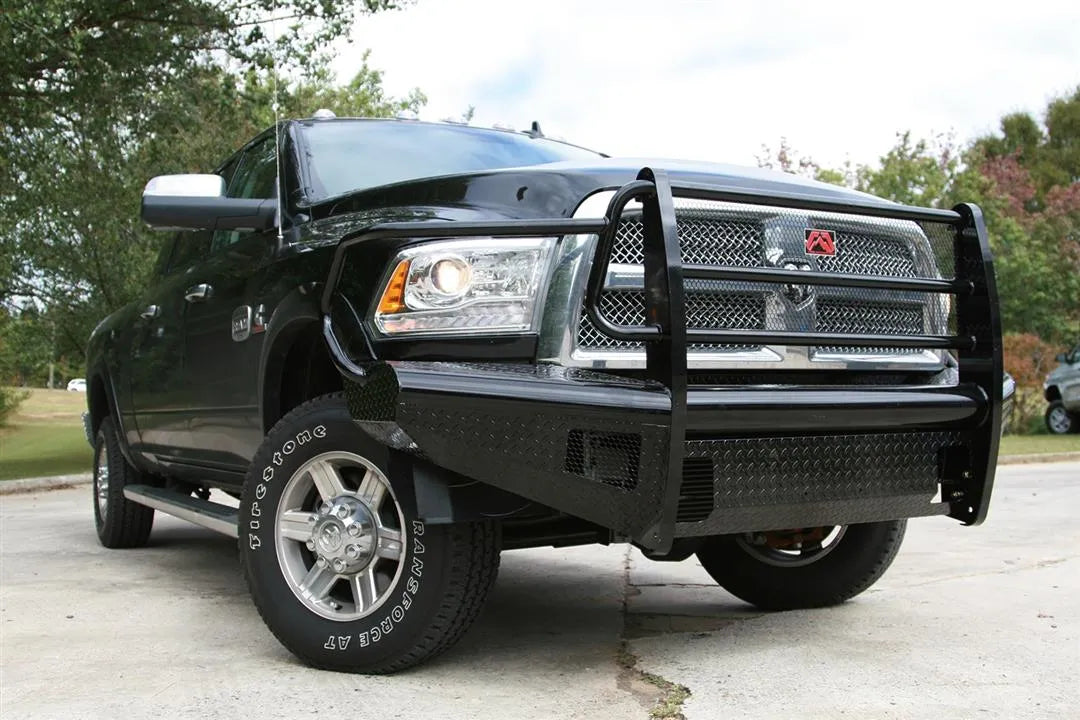 Fab Fours Black Steel front bumper with full guard on a silver Ram 2500, front view outdoors, showing the full grille guard, headlight hoops, and diamond-plate face