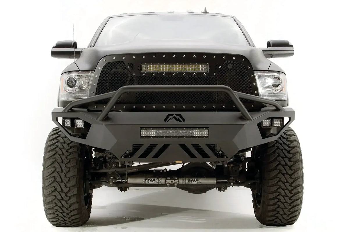 Fab Fours Vengeance front bumper with pre-runner guard on a gray Ram 2500, straight-on front view, showing the pre-runner bar, center LED light bar, and slotted skid plate